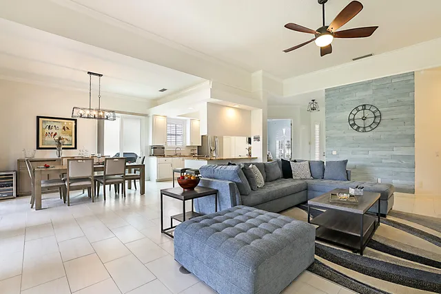 a living room with furniture and a dining table