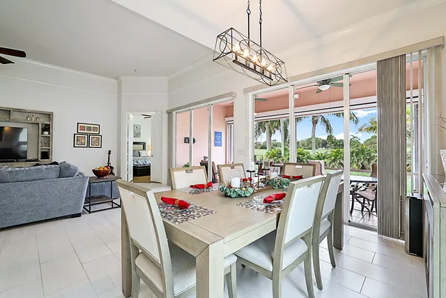 a view of a dining room with furniture large windows and wooden floor