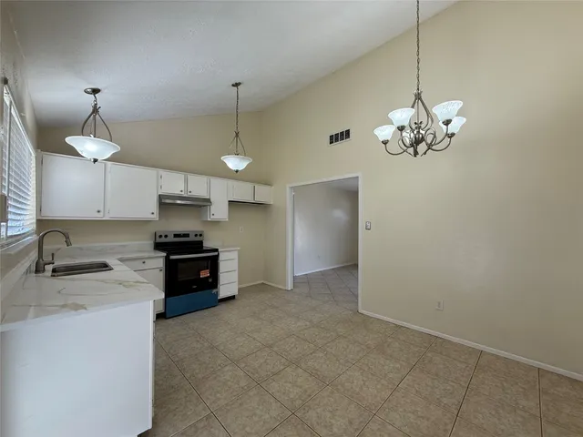 a view of a kitchen with a sink and a stove top oven