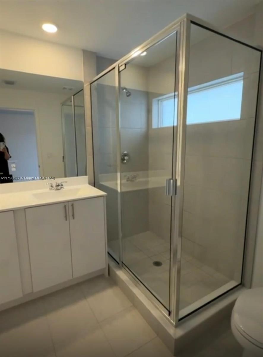 5145 Southwest 37th Street, Unit 5145 Hollywood, FL 33023 - Photo 1 of 6 a bathroom with a shower sink and mirror