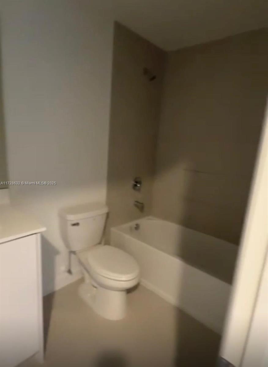 5145 Southwest 37th Street, Unit 5145 Hollywood, FL 33023 - Photo 3 of 6 a white toilet sitting next to a bath tub