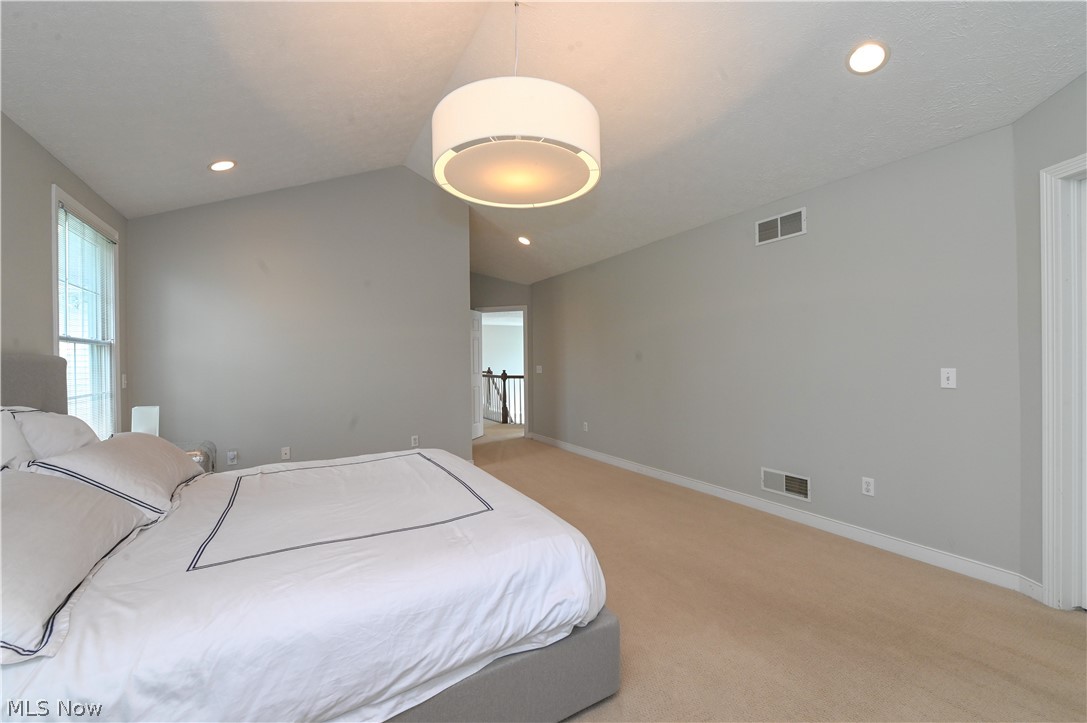 1688 Sheridan Road South Euclid, OH 44121 - Photo 22 of 48 Bedroom with light carpet and vaulted ceiling