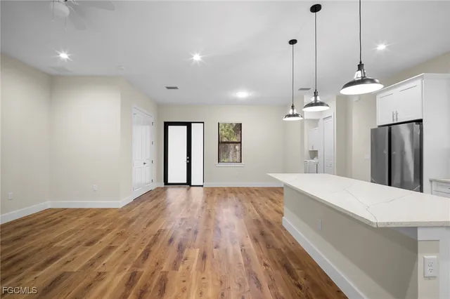 a view of empty room with wooden floor