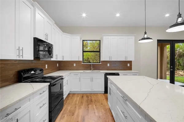 a kitchen with a sink a stove and cabinets