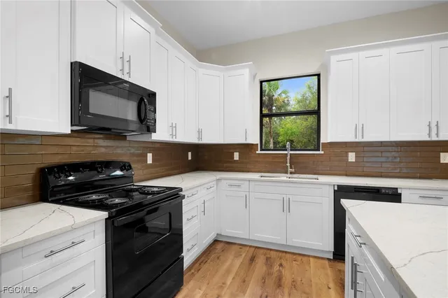a kitchen with a sink stove and microwave