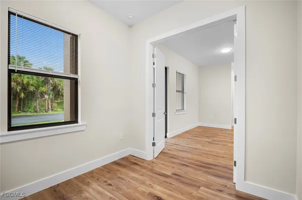 a view of a room with wooden floor and window