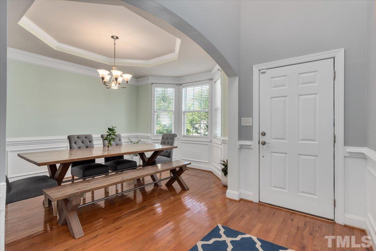 6 Piccadilly Court Durham, NC 27713 - Photo 2 of 27 a view of a dining room with furniture a chandelier and wooden floor