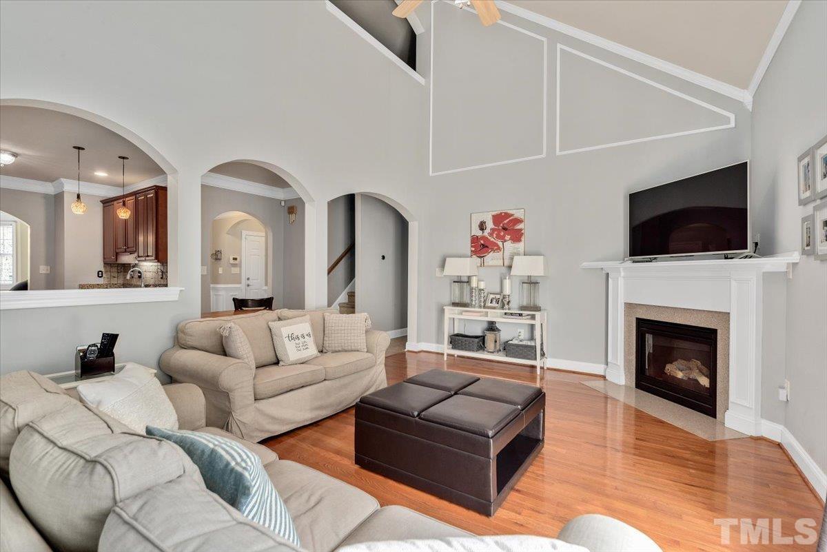 6 Piccadilly Court Durham, NC 27713 - Photo 11 of 27 a living room with furniture a flat screen tv and a fireplace