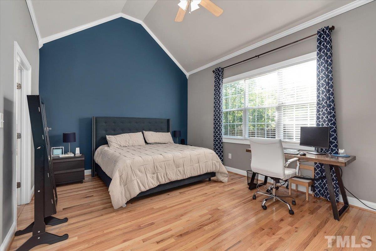 6 Piccadilly Court Durham, NC 27713 - Photo 12 of 27 a bedroom with a bed a desk and chair with wooden floor