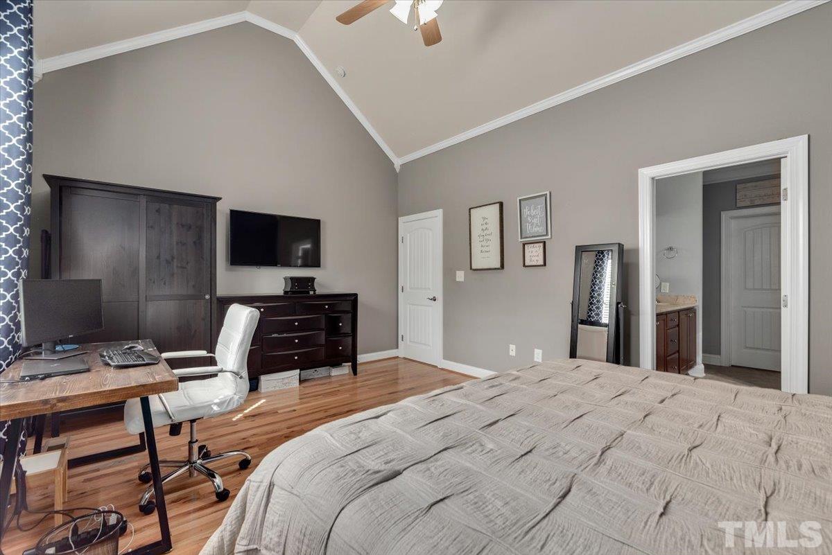 6 Piccadilly Court Durham, NC 27713 - Photo 13 of 27 a bedroom with a bed and a flat screen tv