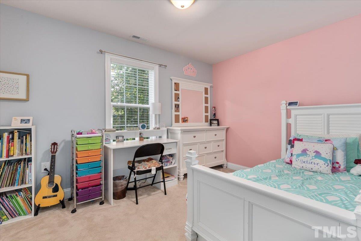 6 Piccadilly Court Durham, NC 27713 - Photo 16 of 27 a bedroom with a bed and a book shelf