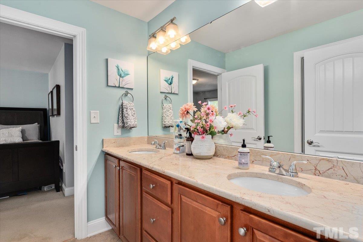 6 Piccadilly Court Durham, NC 27713 - Photo 19 of 27 a bathroom with a granite countertop sink and a mirror