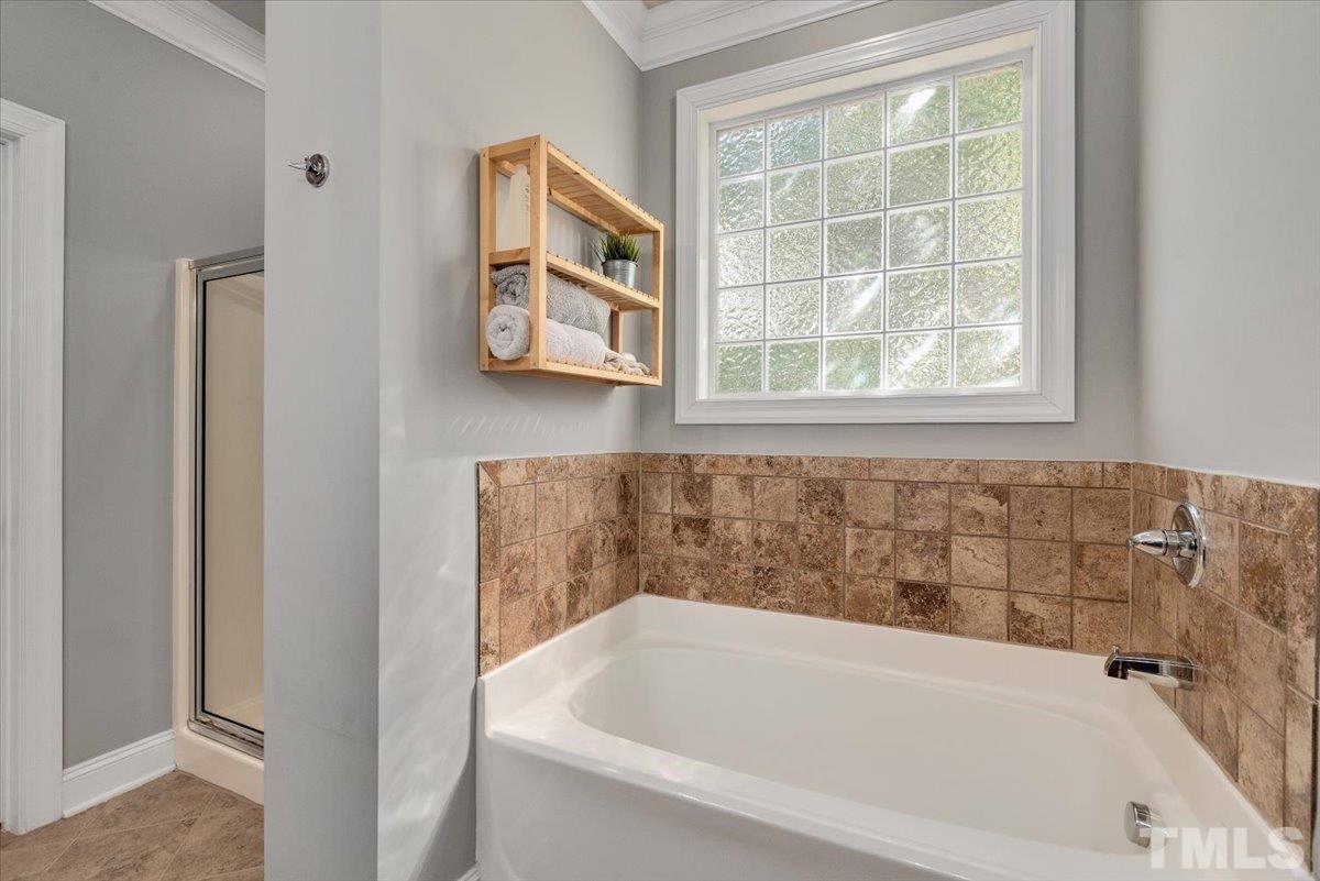 6 Piccadilly Court Durham, NC 27713 - Photo 21 of 27 a white bath tub sitting next to a window