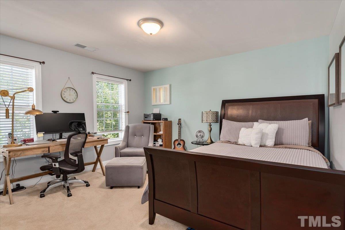 6 Piccadilly Court Durham, NC 27713 - Photo 22 of 27 a bedroom with a bed a desk and chair