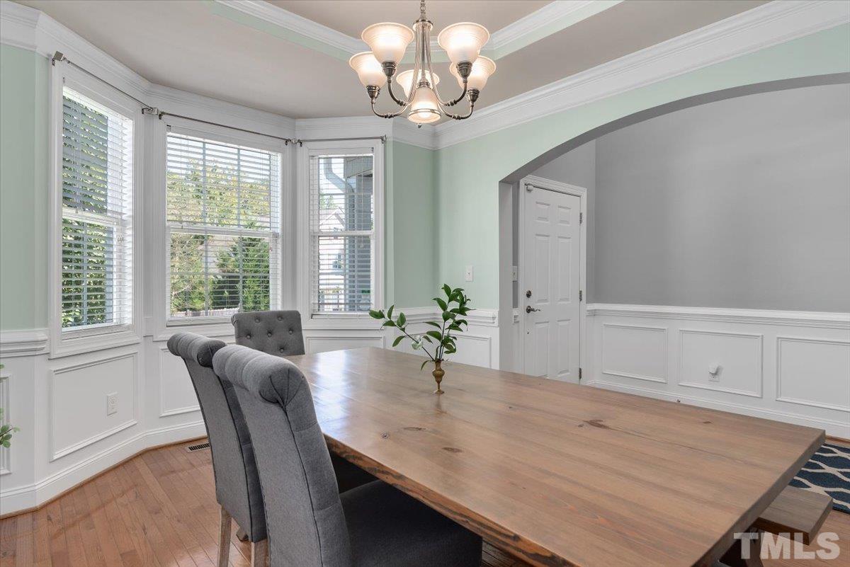 6 Piccadilly Court Durham, NC 27713 - Photo 4 of 27 a dining room with wooden floor a chandelier a wooden table and chairs