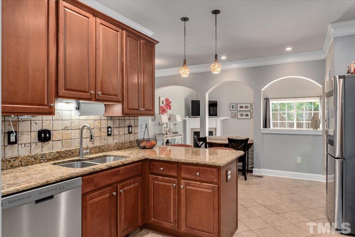 6 Piccadilly Court Durham, NC 27713 - Photo 8 of 27 a kitchen with stainless steel appliances granite countertop a sink a stove cabinets and a dining table