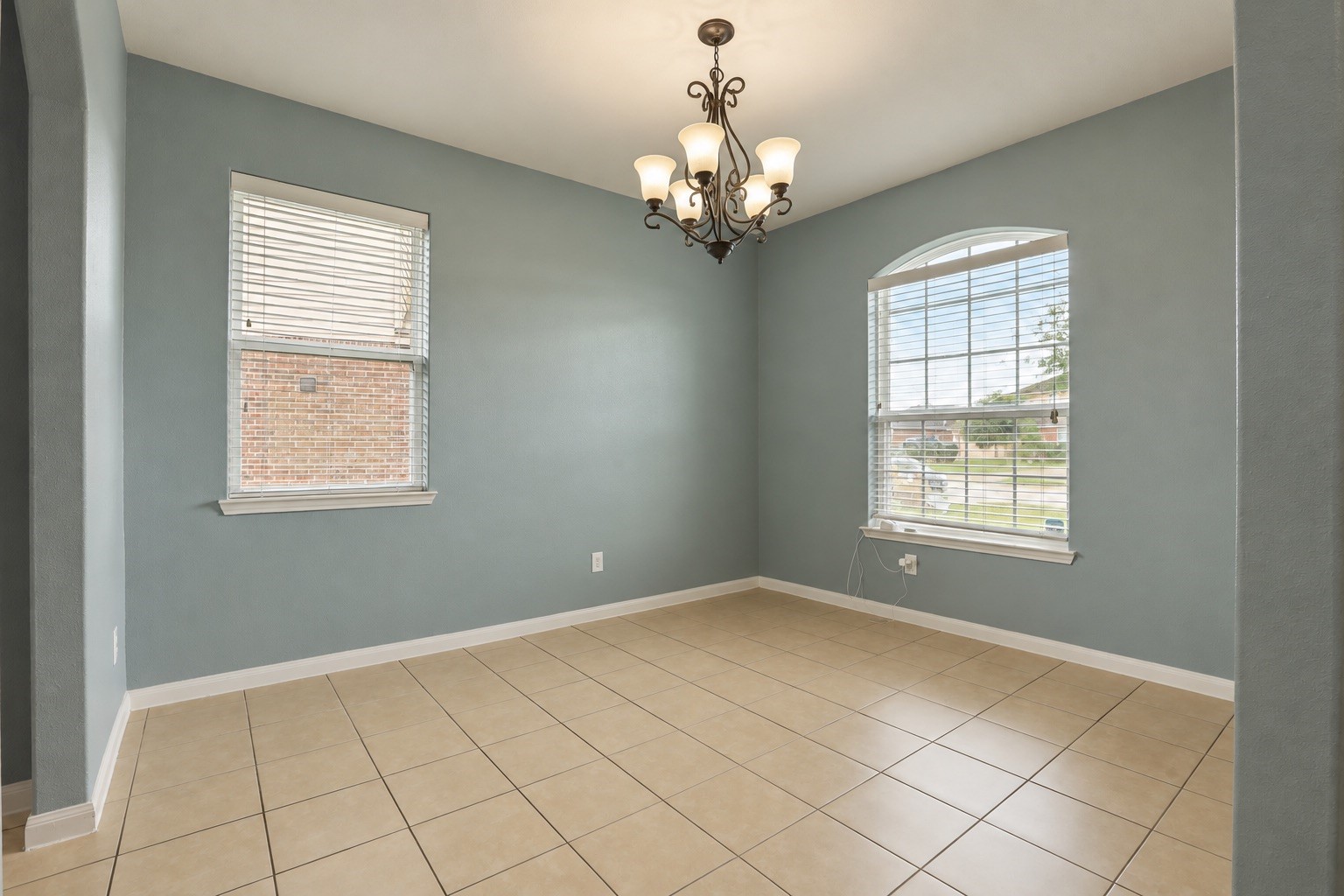 1634 Pink Stone Drive Rosharon, TX 77583 - Photo 12 of 38 Living room features tile and opens into the kitchen area.