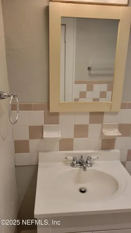 a bathroom with a sink and mirror