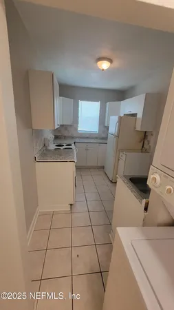 a kitchen with a sink and a stove top oven