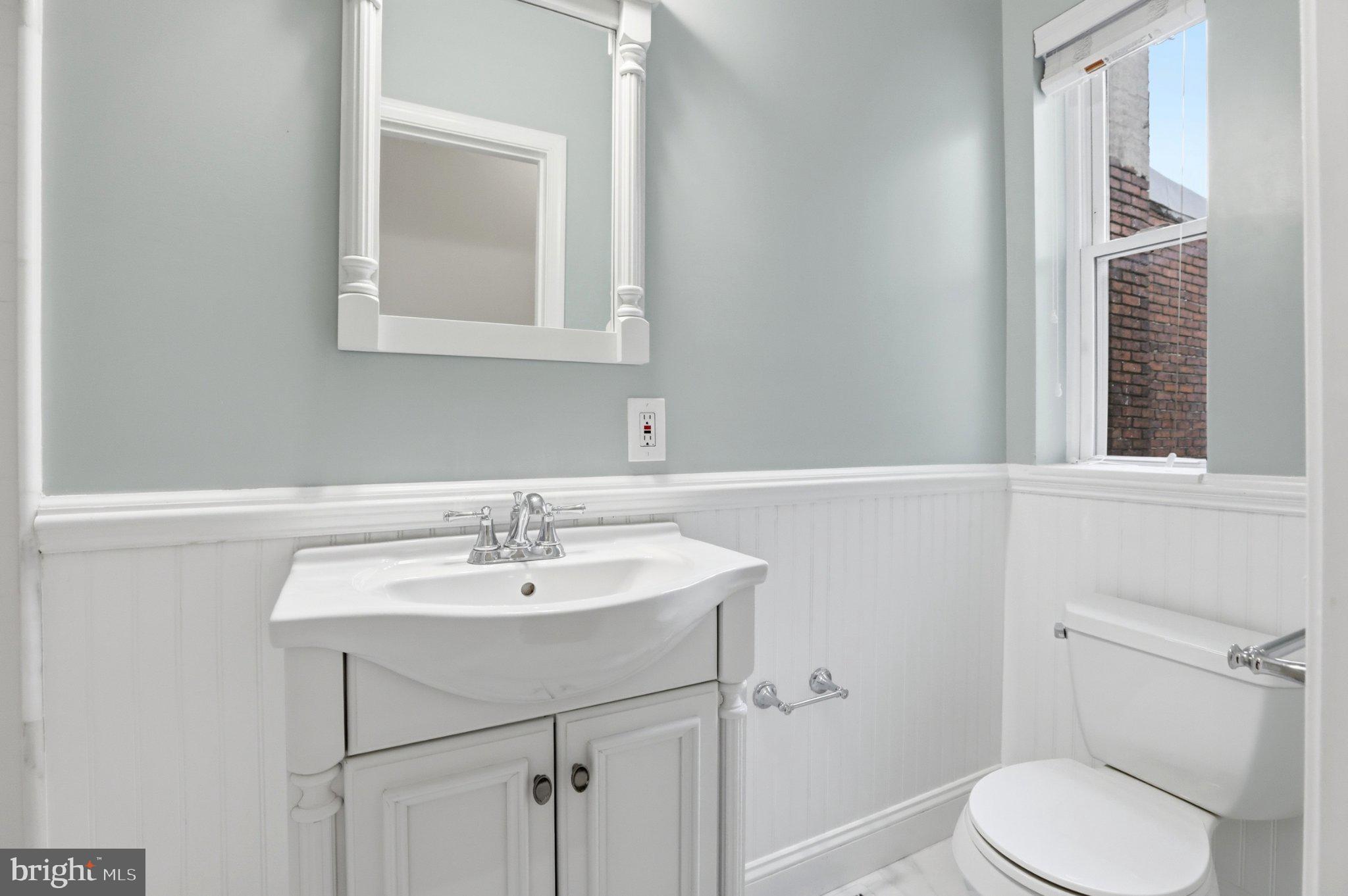 222 South Exeter Street Baltimore, MD 21202 - Photo 20 of 41 a bathroom with a sink toilet and mirror