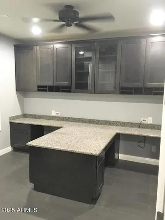 a kitchen with a cabinets and chandelier