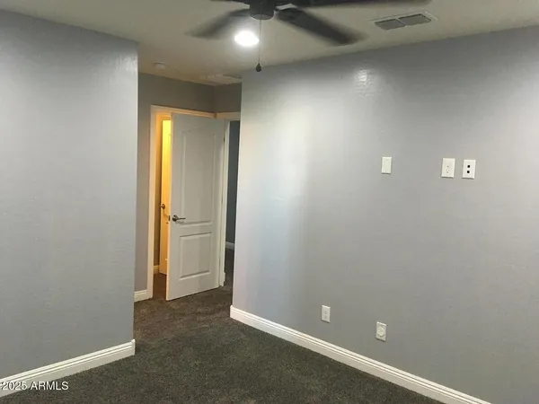 an empty room with closet and a bathroom