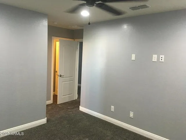 an empty room with closet and a bathroom