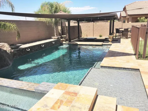 a view of a swimming pool with a patio