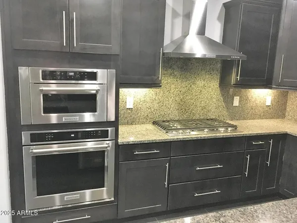 a stove top oven sitting inside of a kitchen