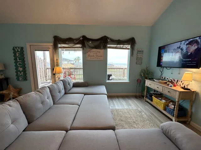 a view of a refrigerator in kitchen and an empty room