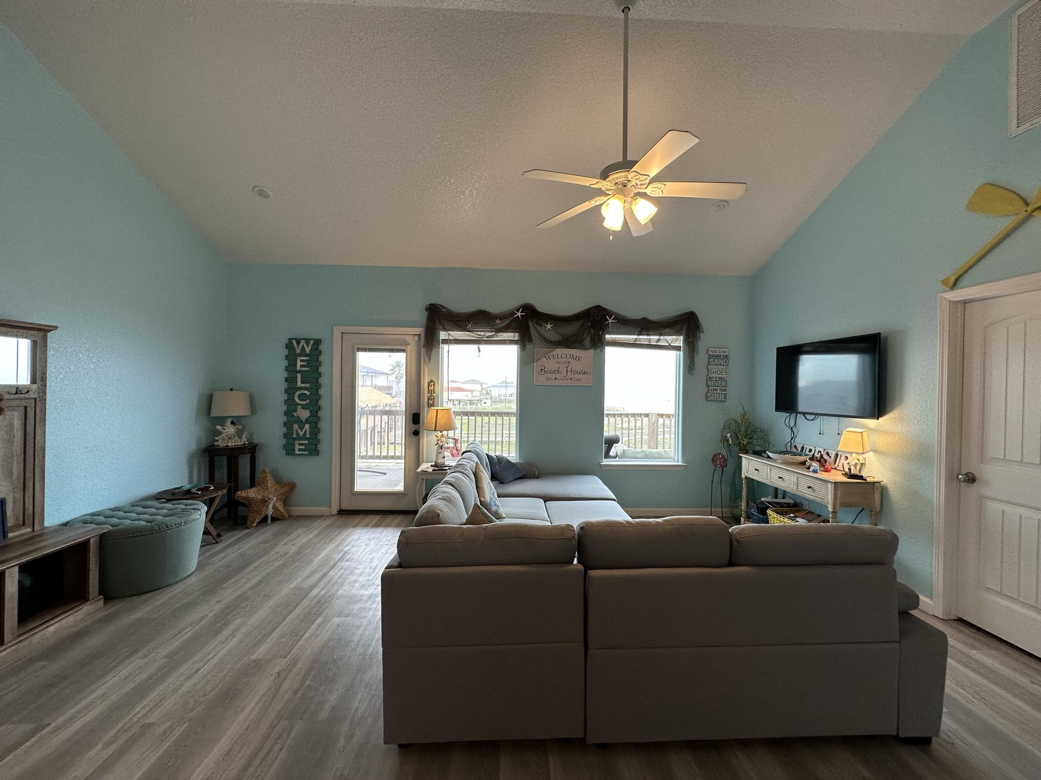 124 Howard Avenue, Unit D Surfside Beach, TX 77541 - Photo 17 of 50 a living room with furniture and a flat screen tv