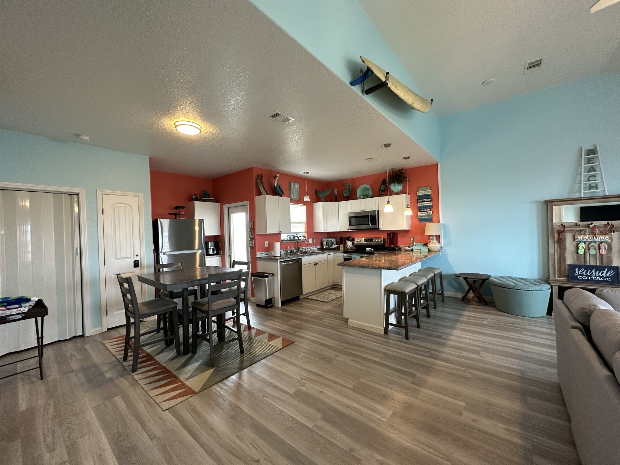 124 Howard Avenue, Unit D Surfside Beach, TX 77541 - Photo 18 of 50 a view of a dining room with furniture window and wooden floor
