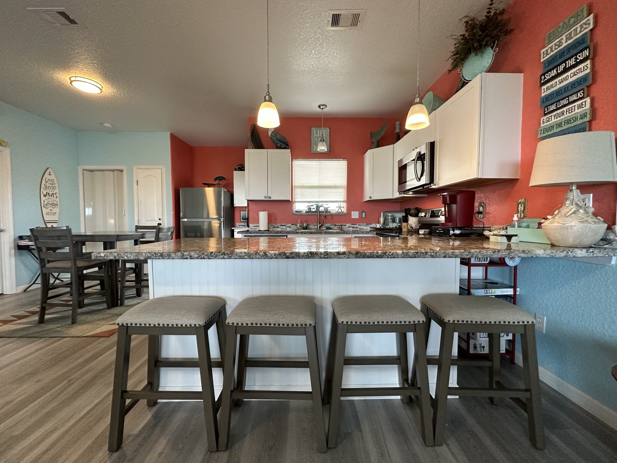 124 Howard Avenue, Unit D Surfside Beach, TX 77541 - Photo 19 of 50 a kitchen with a table chairs stove and cabinets