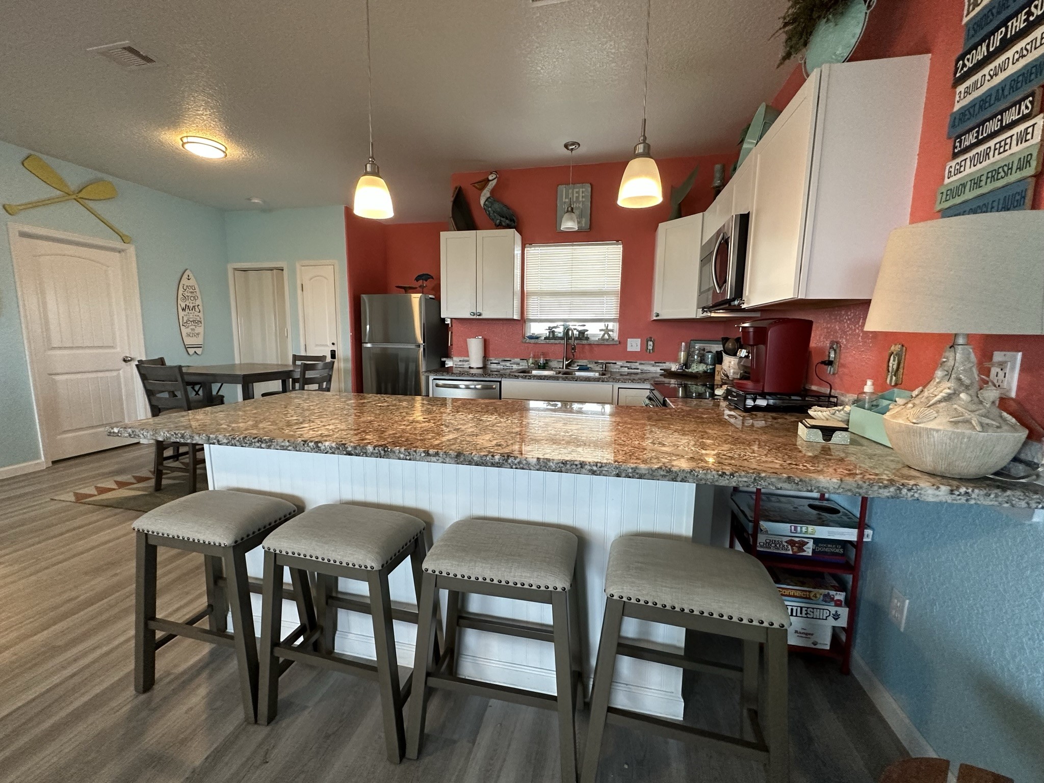 124 Howard Avenue, Unit D Surfside Beach, TX 77541 - Photo 20 of 50 a kitchen with lots of wooden cabinets appliances and dining table