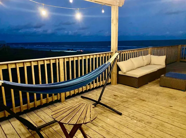 a view of balcony with wooden floor and seating space