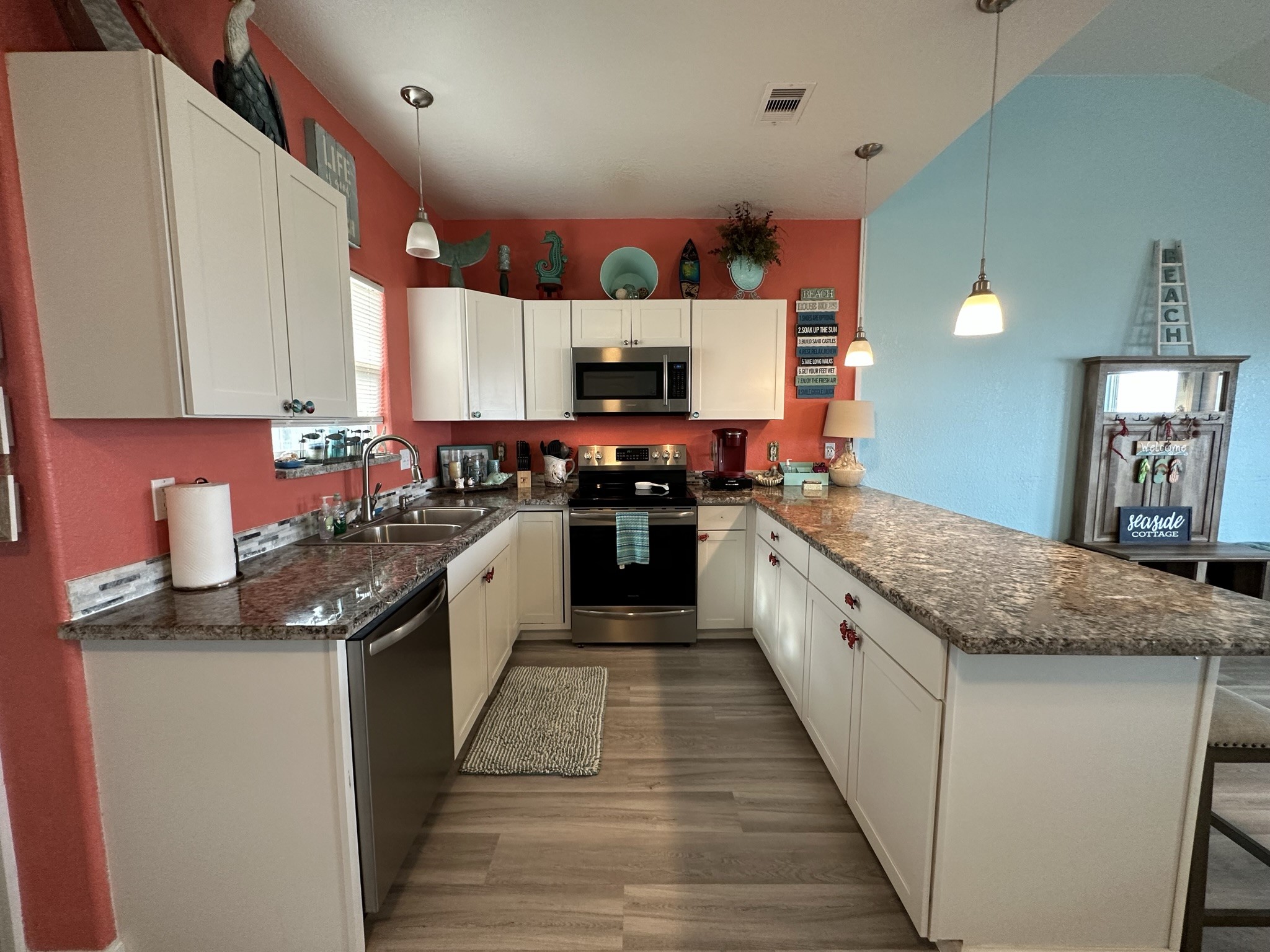 124 Howard Avenue, Unit D Surfside Beach, TX 77541 - Photo 21 of 50 a large kitchen with stainless steel appliances granite countertop a stove and a sink