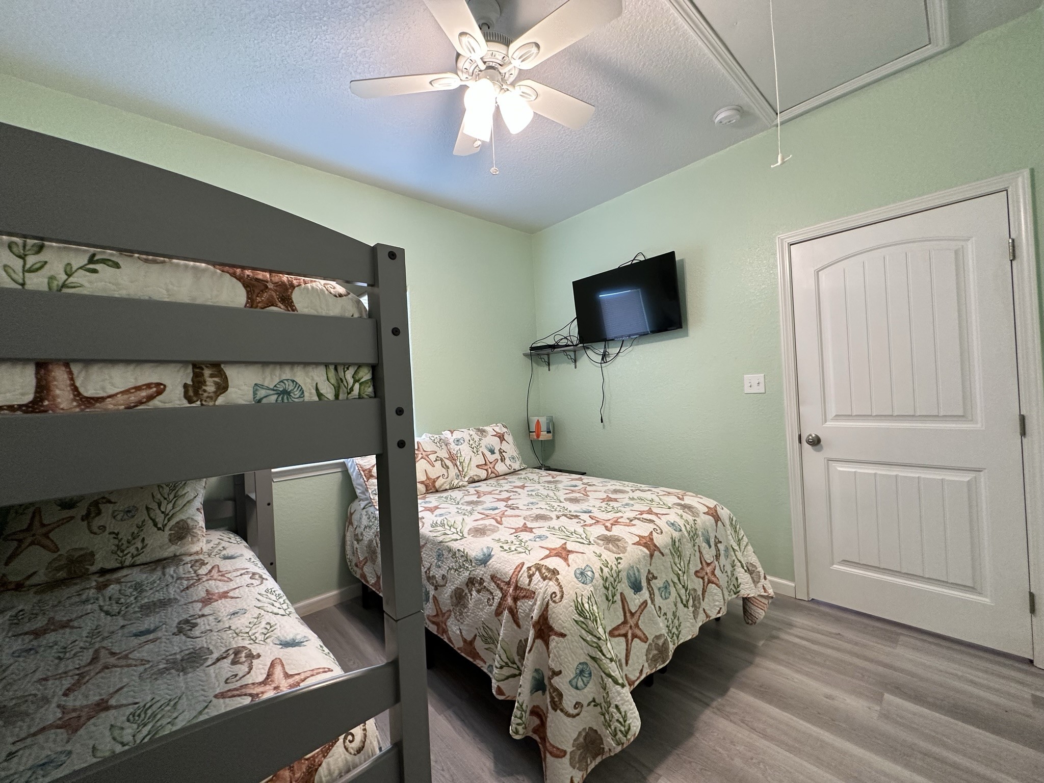 124 Howard Avenue, Unit D Surfside Beach, TX 77541 - Photo 27 of 50 a bedroom with a bed and a television