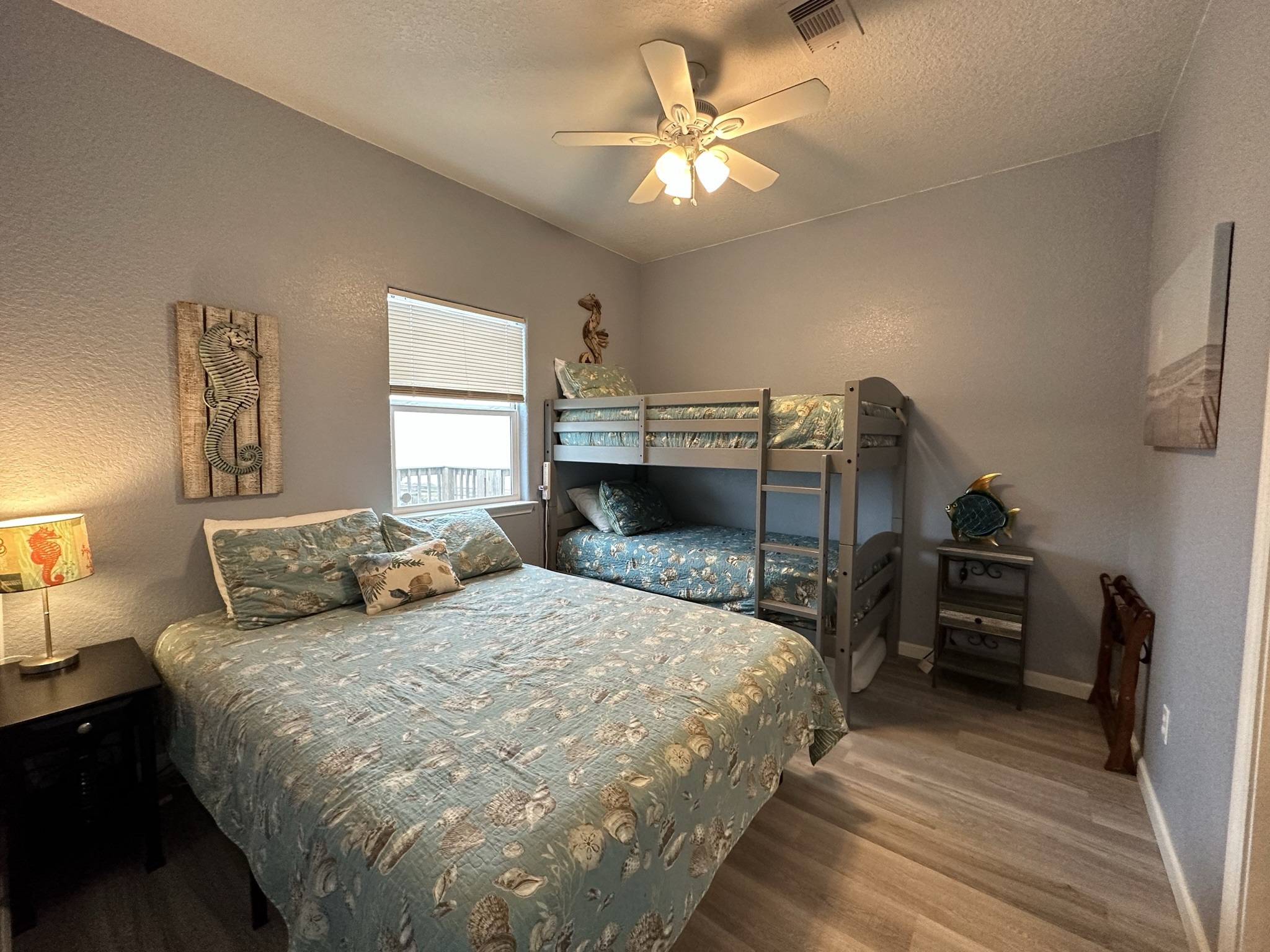 124 Howard Avenue, Unit D Surfside Beach, TX 77541 - Photo 29 of 50 a bedroom with a bed and a chandelier