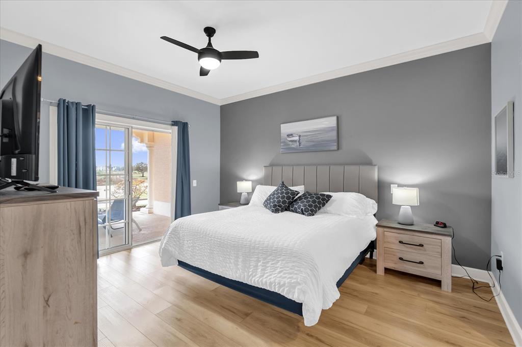 1362 Centre Ct Ridge Drive, Unit 102 Reunion, FL 34747 - Photo 10 of 35 a bedroom with a bed and large windows