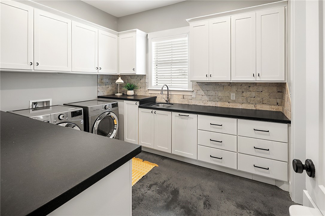 7323 River Ridge Drive College Station, TX 77845 - Photo 21 of 39 a kitchen with cabinets appliances a sink and a window