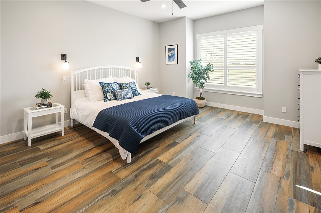 7323 River Ridge Drive College Station, TX 77845 - Photo 22 of 39 a bedroom with a bed and wooden floor