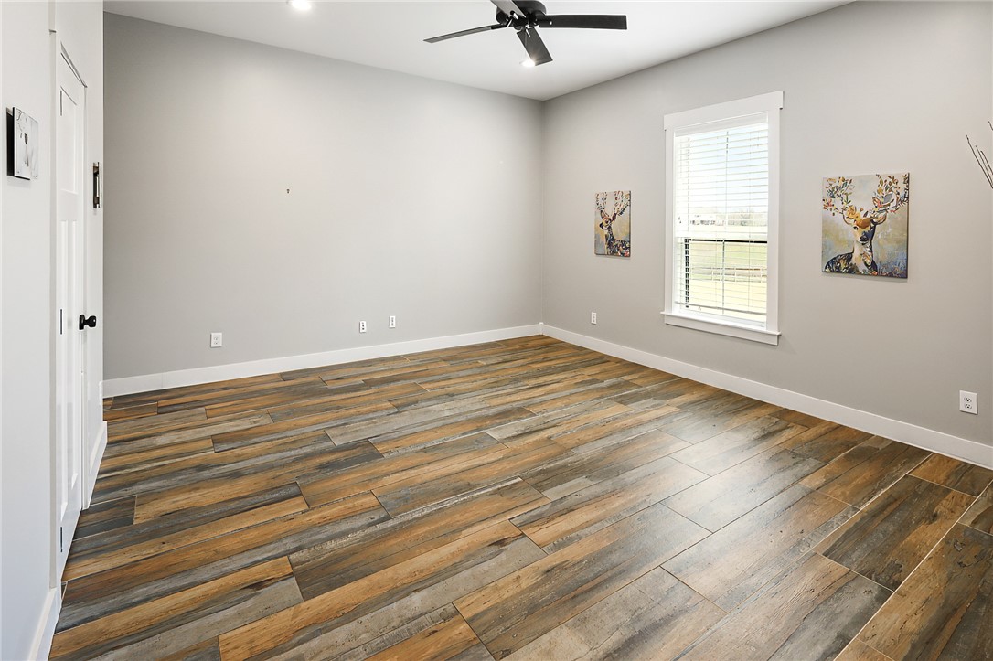 7323 River Ridge Drive College Station, TX 77845 - Photo 26 of 39 wooden floor in an empty room with a window