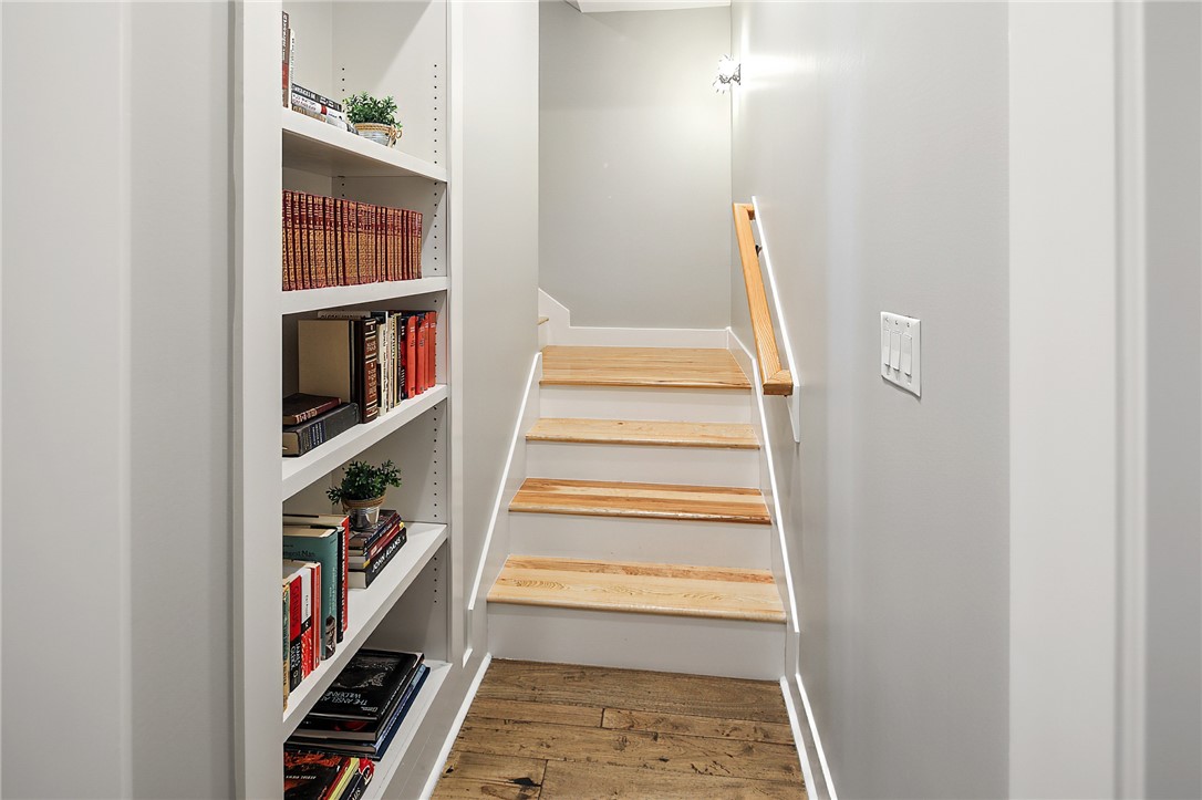 7323 River Ridge Drive College Station, TX 77845 - Photo 28 of 39 a view of a bedroom with wooden floor and book shelf