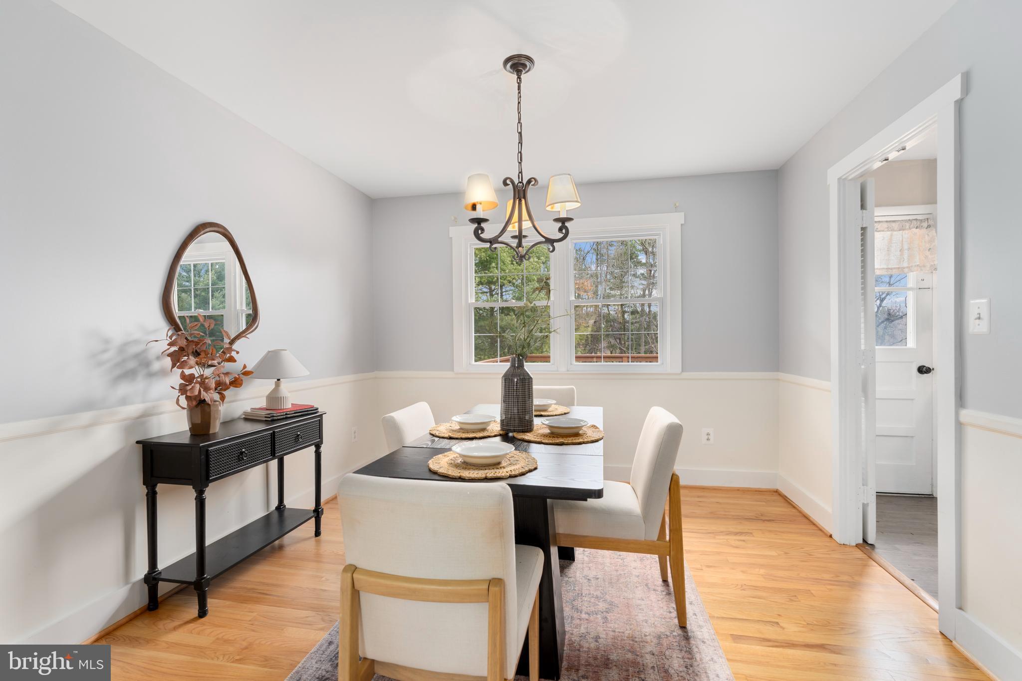 4406 Old Farm Road Baldwin, MD 21013 - Photo 12 of 49 a dining room with furniture a chandelier and wooden floor