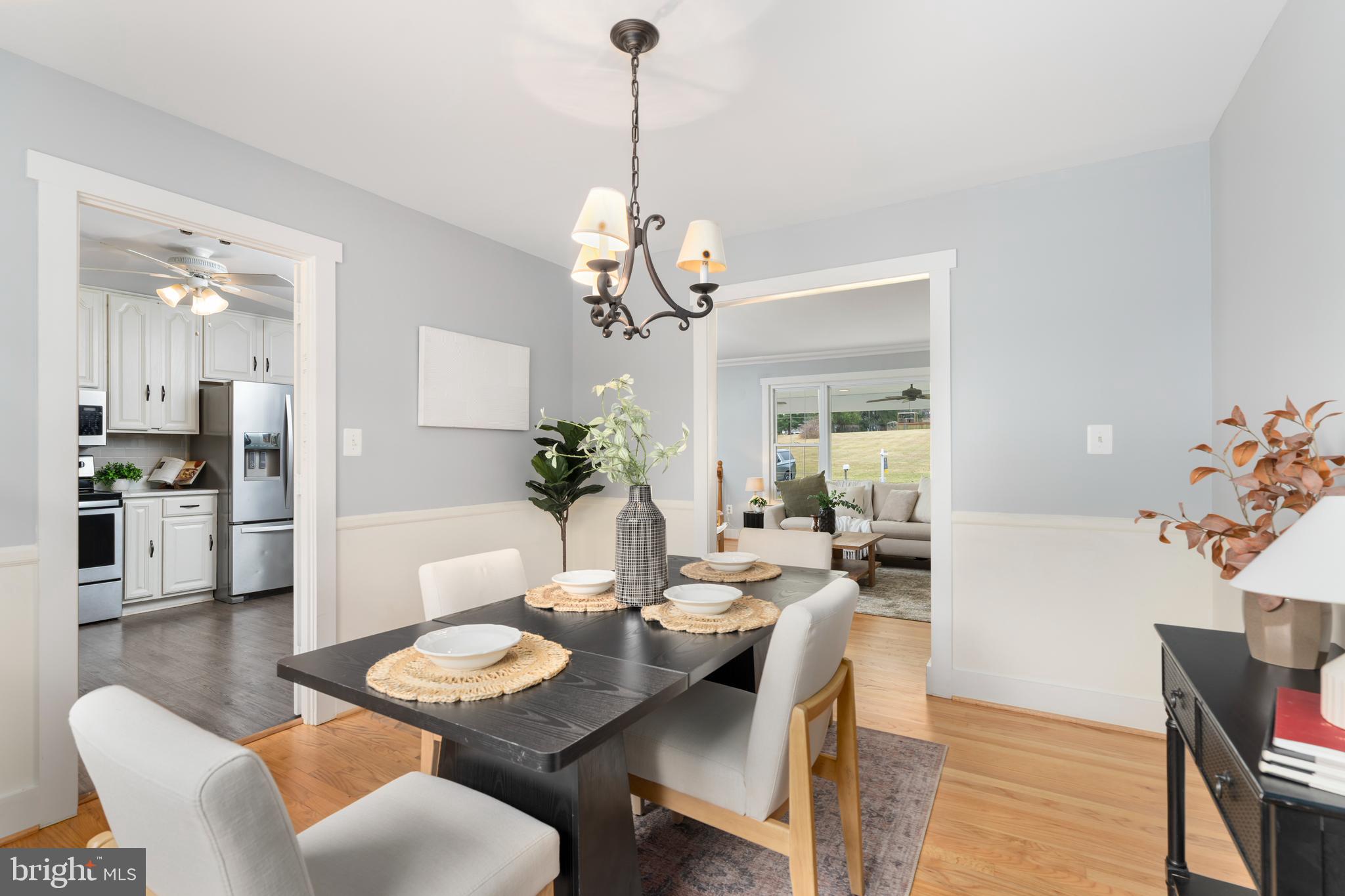 4406 Old Farm Road Baldwin, MD 21013 - Photo 14 of 49 a dining room with furniture a chandelier and wooden floor