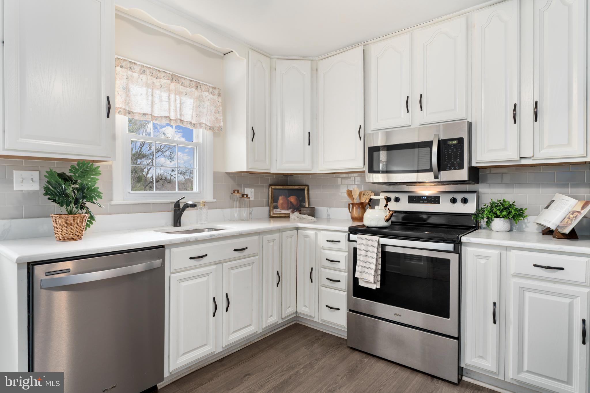 4406 Old Farm Road Baldwin, MD 21013 - Photo 16 of 49 a kitchen with white cabinets stainless steel appliances and sink