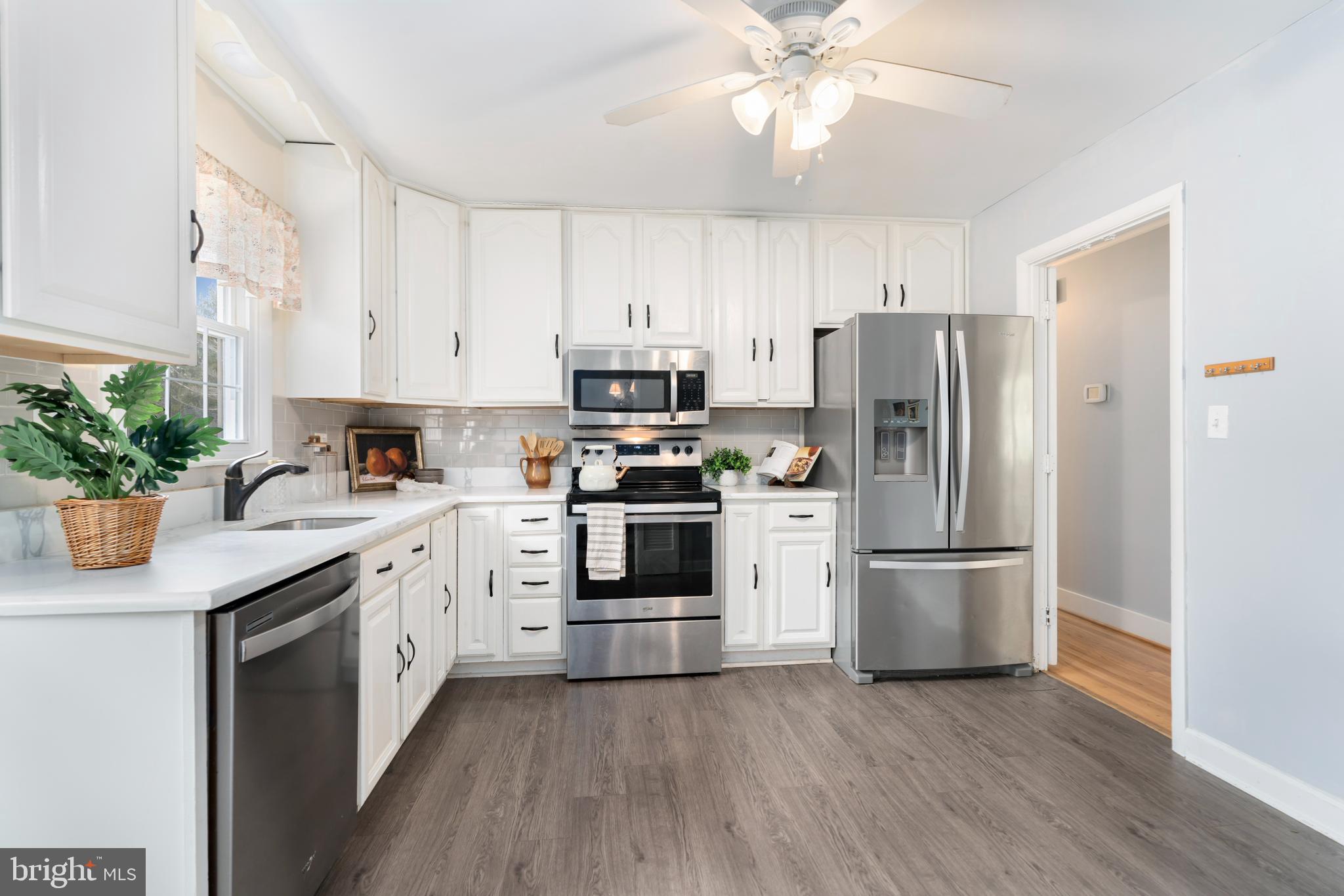 4406 Old Farm Road Baldwin, MD 21013 - Photo 17 of 49 a kitchen with stainless steel appliances a refrigerator sink and microwave