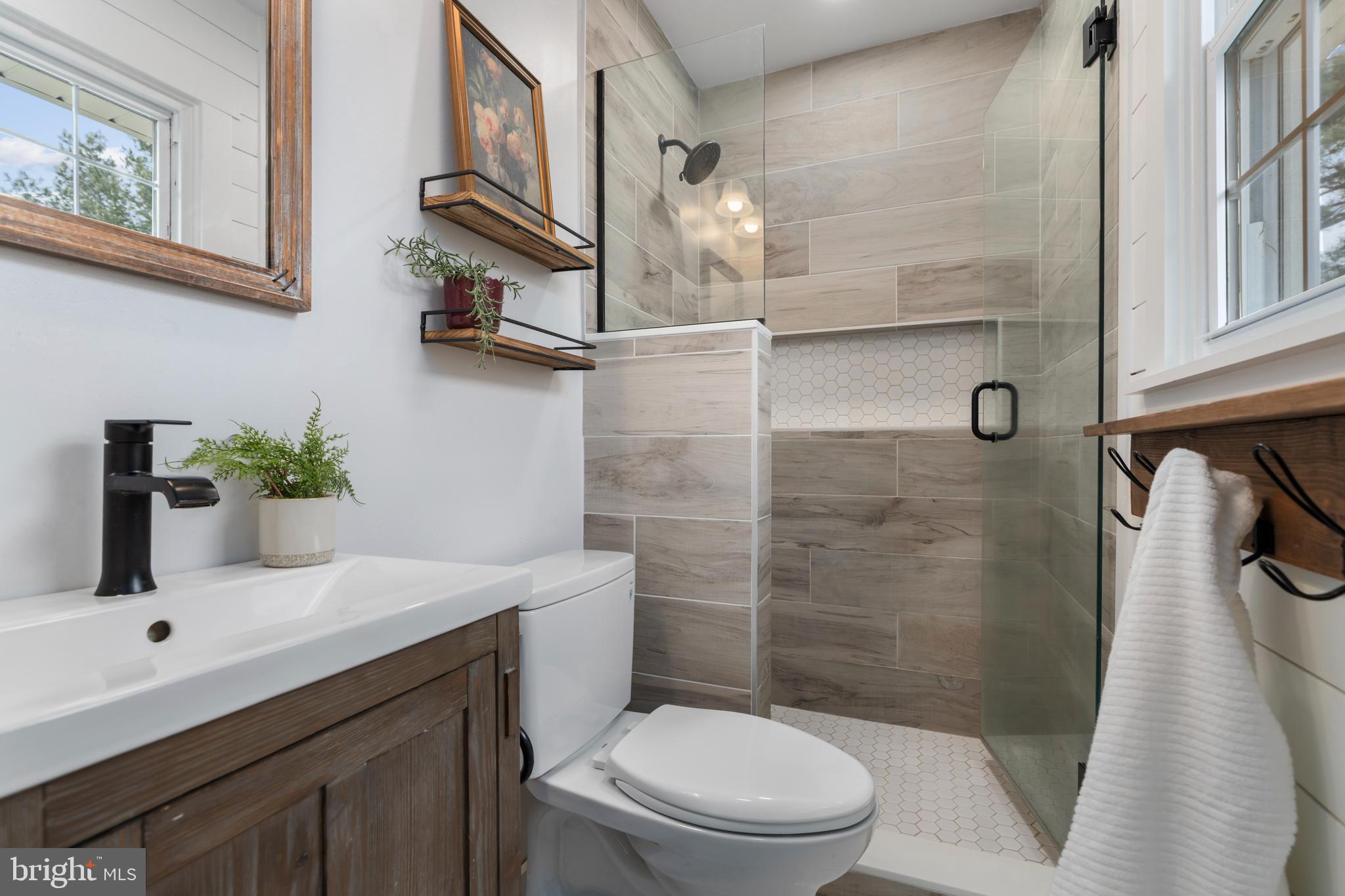4406 Old Farm Road Baldwin, MD 21013 - Photo 22 of 49 a bathroom with a sink a toilet a mirror and shower