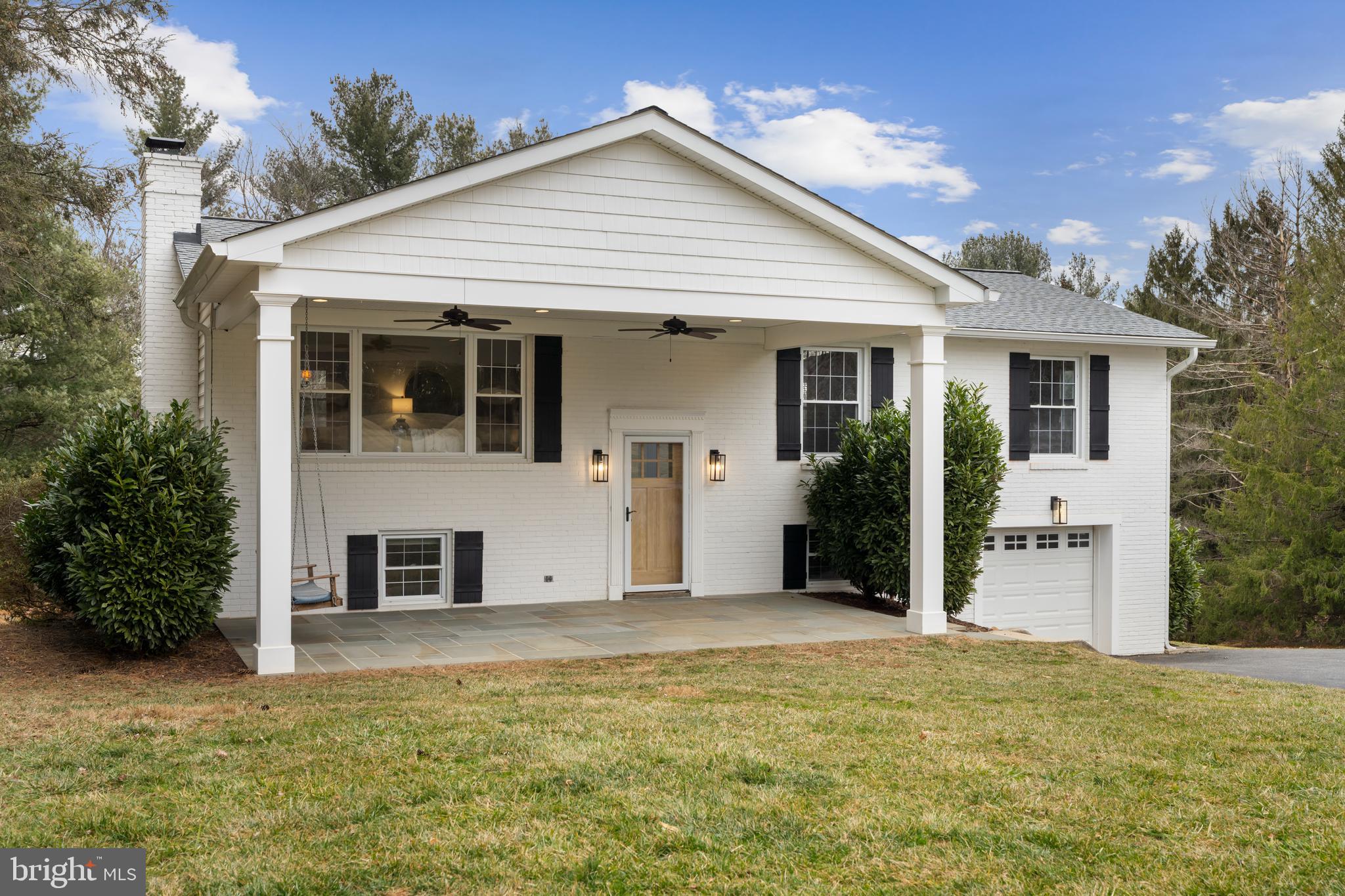 4406 Old Farm Road Baldwin, MD 21013 - Photo 4 of 49 a view of a white house with a yard and potted plants