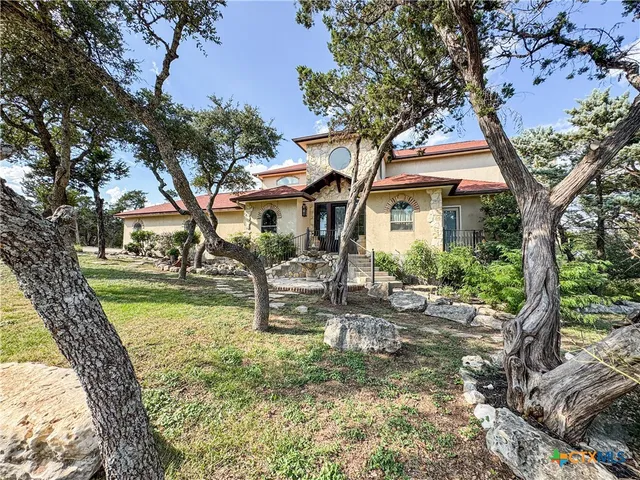 a view of a house with backyard porch and sitting area